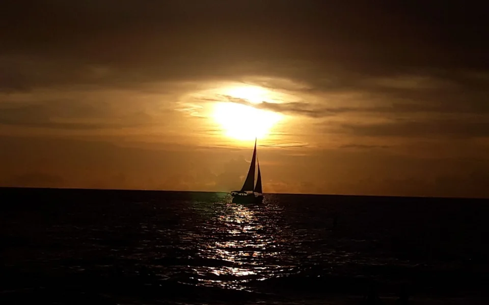 A sailboat crossing the Gulf at sunset near Venice, Florida
