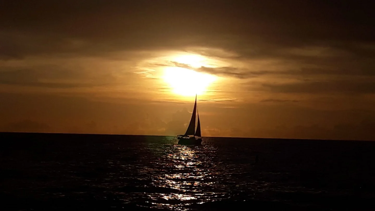 A sailboat crossing the Gulf at sunset near Venice, Florida