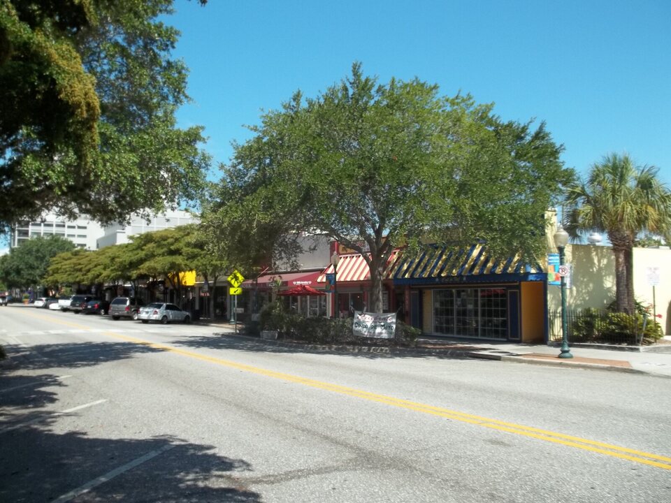 Colorful shops beneath shade trees in downtown Sarasota