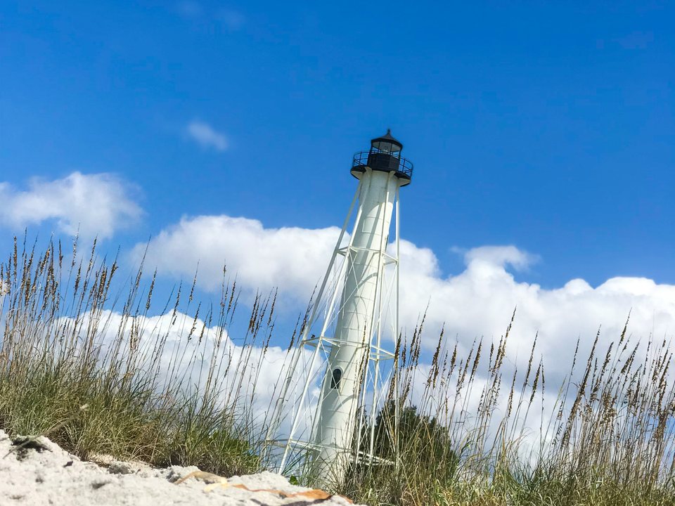 Boca Grande Lighthouse rising above beach grass and sand