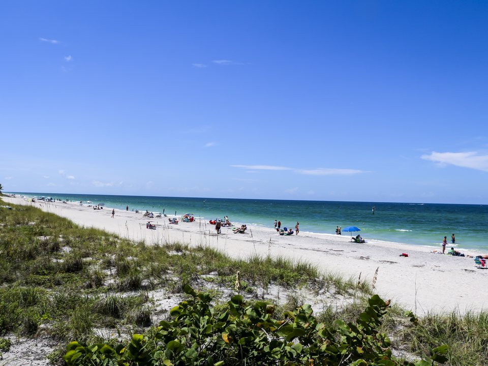 Englewood Beach shoreline with Gulf water, dunes, and beachgoers