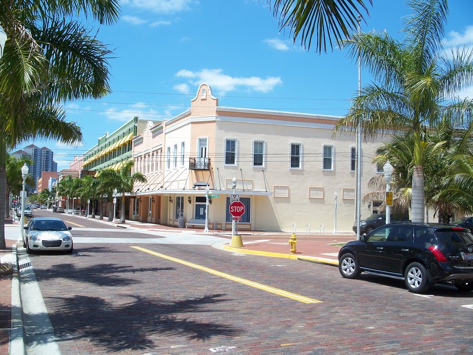 Historic downtown Fort Myers streetscape with palms and brick paving